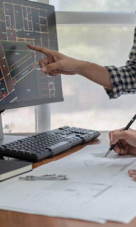 engineers-discuss-blueprint-while-checking-information-tablet-computer-office