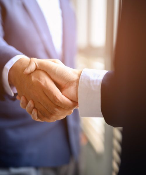 two-businessmen-join-hands-business-cooperation